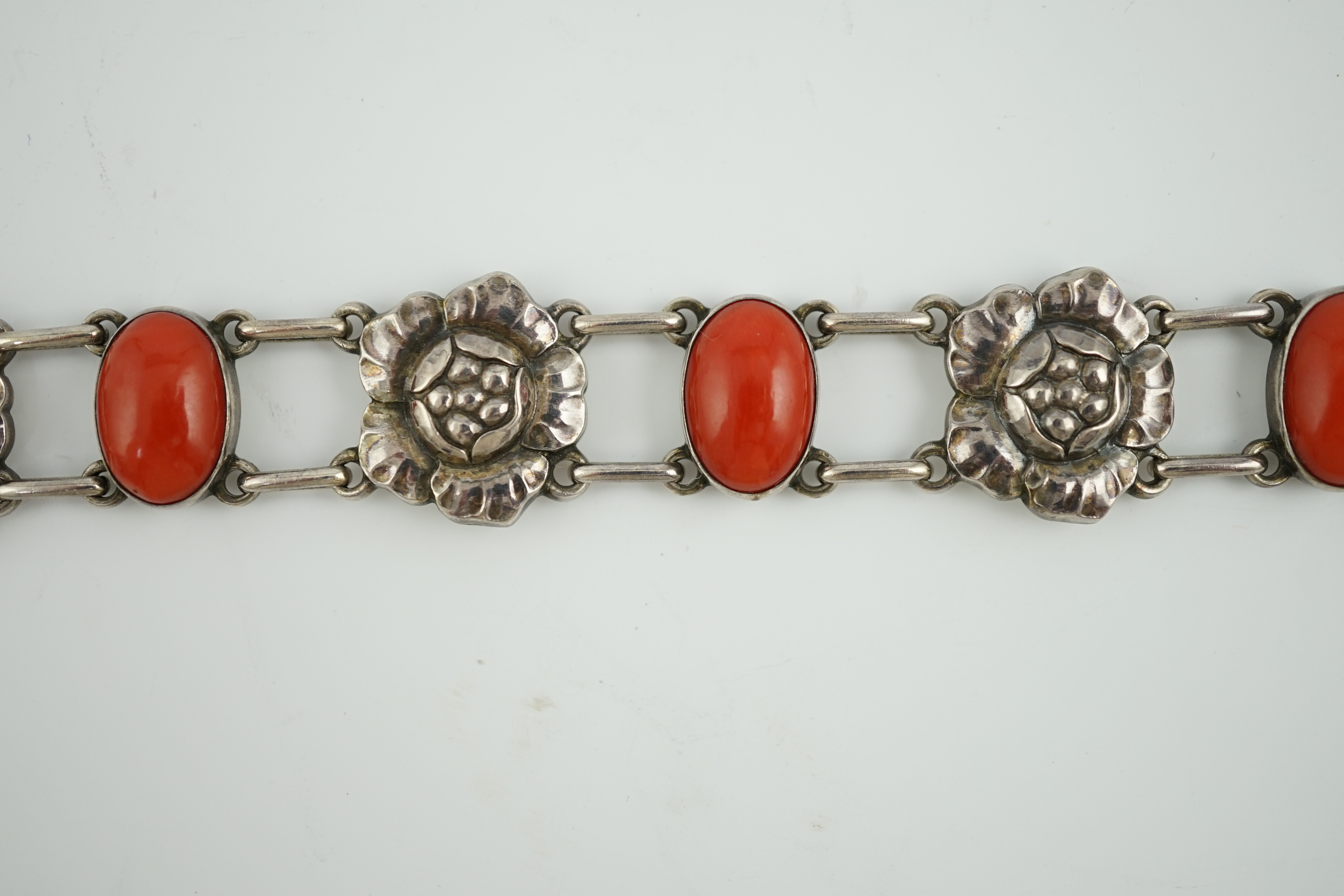 A George Jensen sterling silver and four stone cabochon coral set bracelet